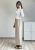 Luźne spodnie kopertowe beżowe miękka tkanina wygodny fason styl nowoczesny Spodnie beżowe szerokie nogawki wiązanie w talii outfit elegancko codzienny